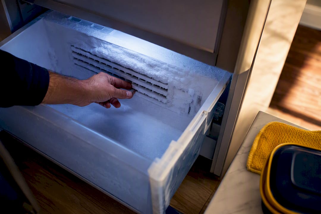 Hand Inspecting Frost Covered Freezer Vent